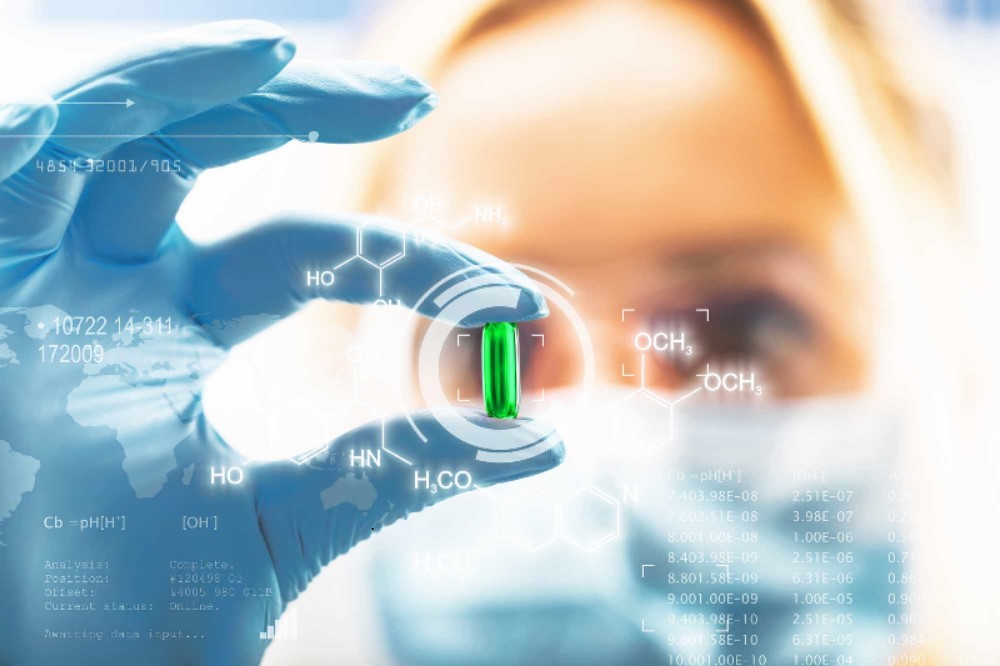 Image showing scientist studying a pill