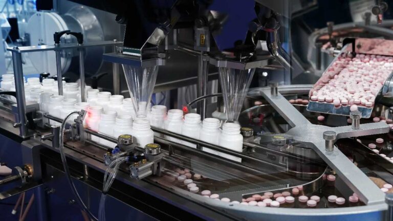 An image of the bottles being packed with medicines inside a plant
